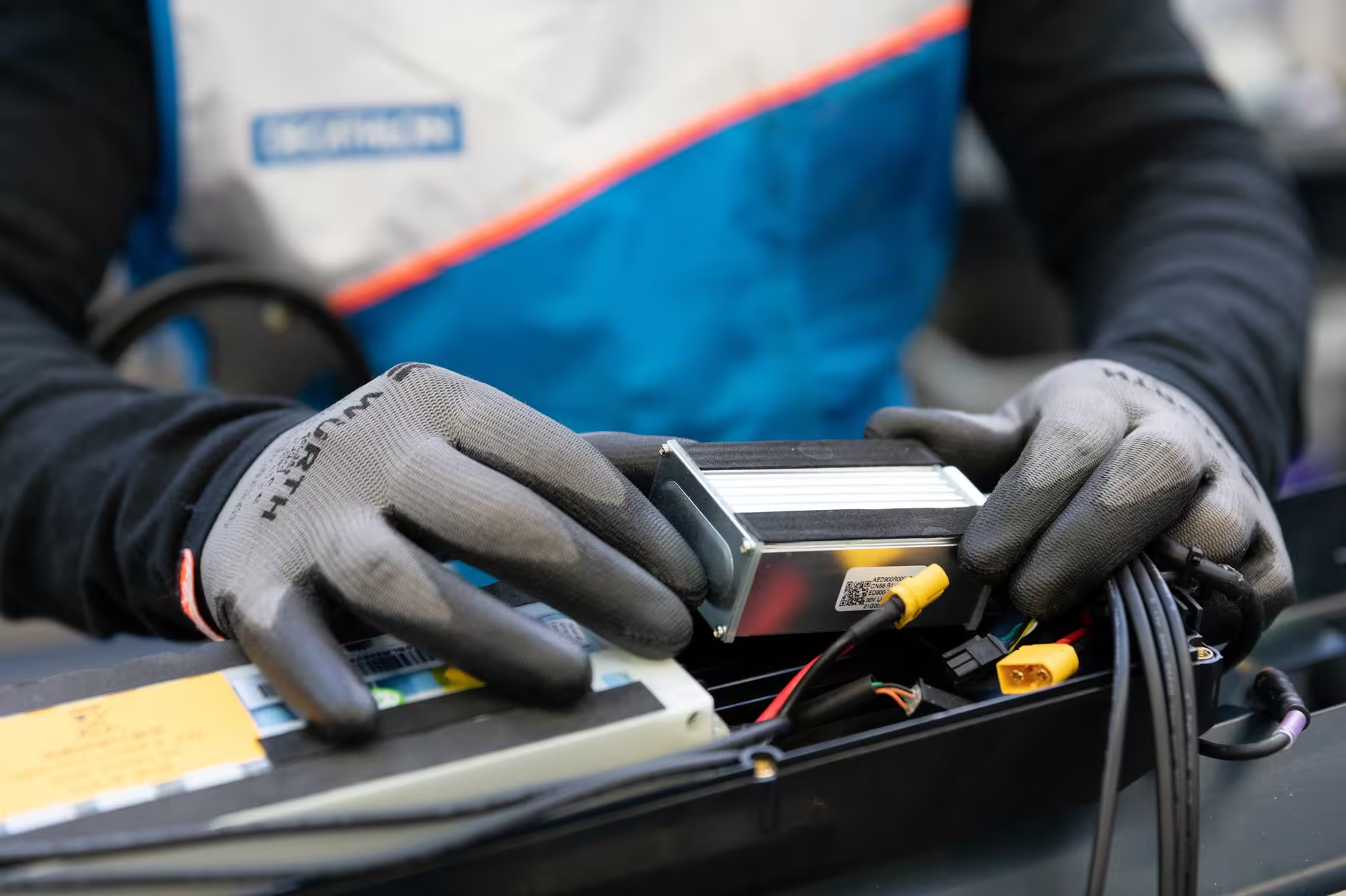 Fachperson wartet Elektrik und Steuergerät eines E-Rollers
